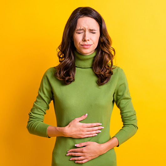 A person in discomfort because of digestive disorders.